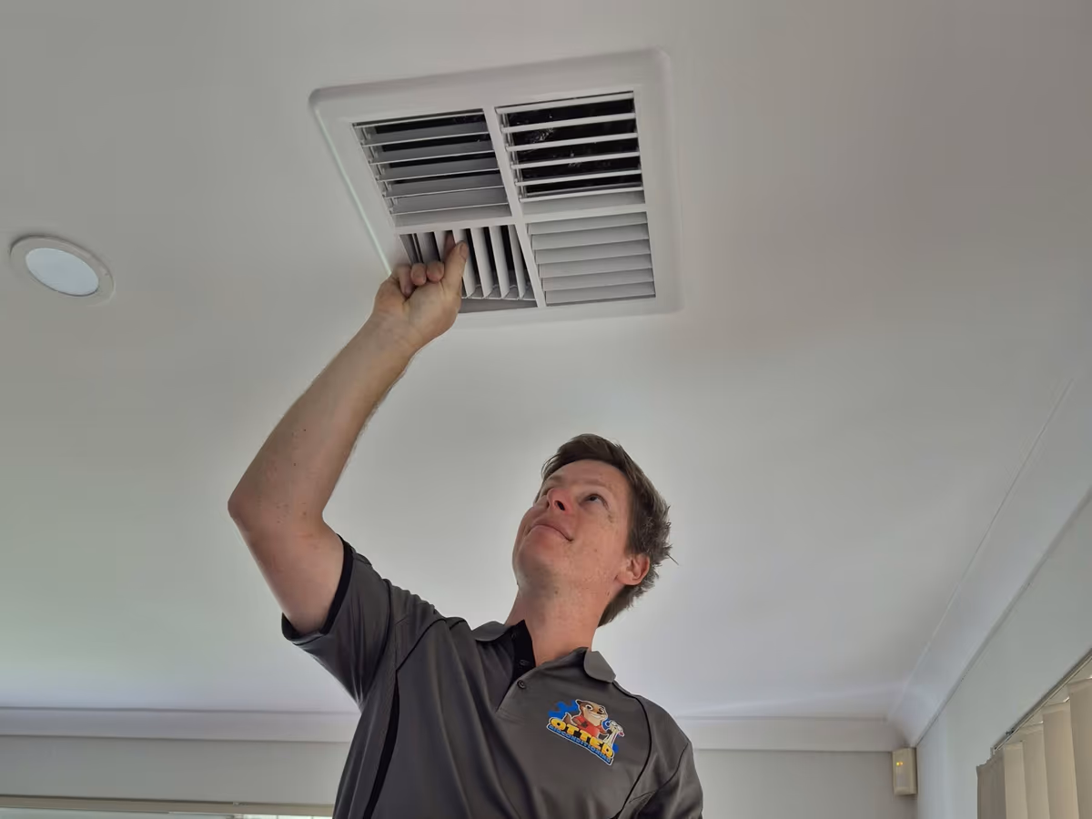 Matt from Otter Air installing a ducted air conditioning vent in a Perth home