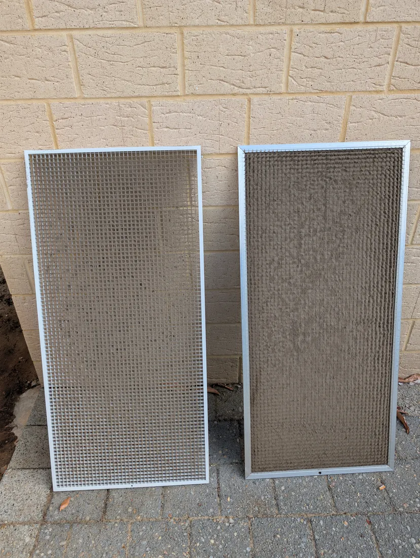 Heavily dust-clogged air conditioner return-air filters from a Perth home