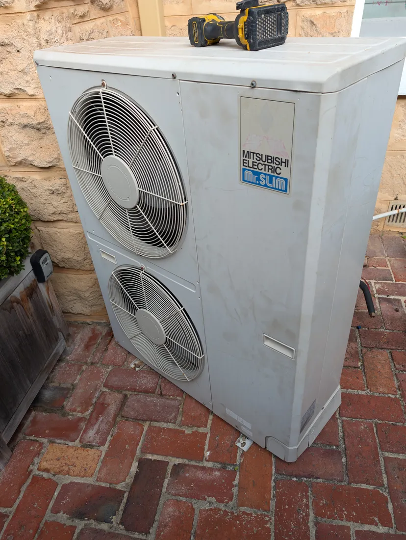 Old failed Mitsubishi Electric ducted air conditioner outdoor unit in Perth