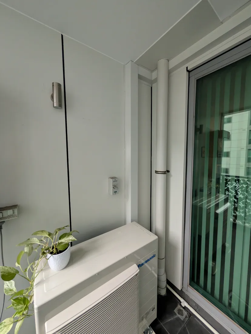New 3-head Panasonic multi-split with concealed custom pipe covers on a Success apartment balcony