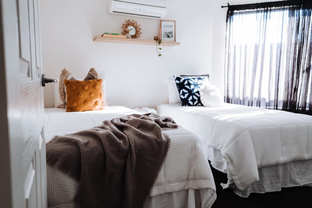 Separate beds in bedroom in sunlight